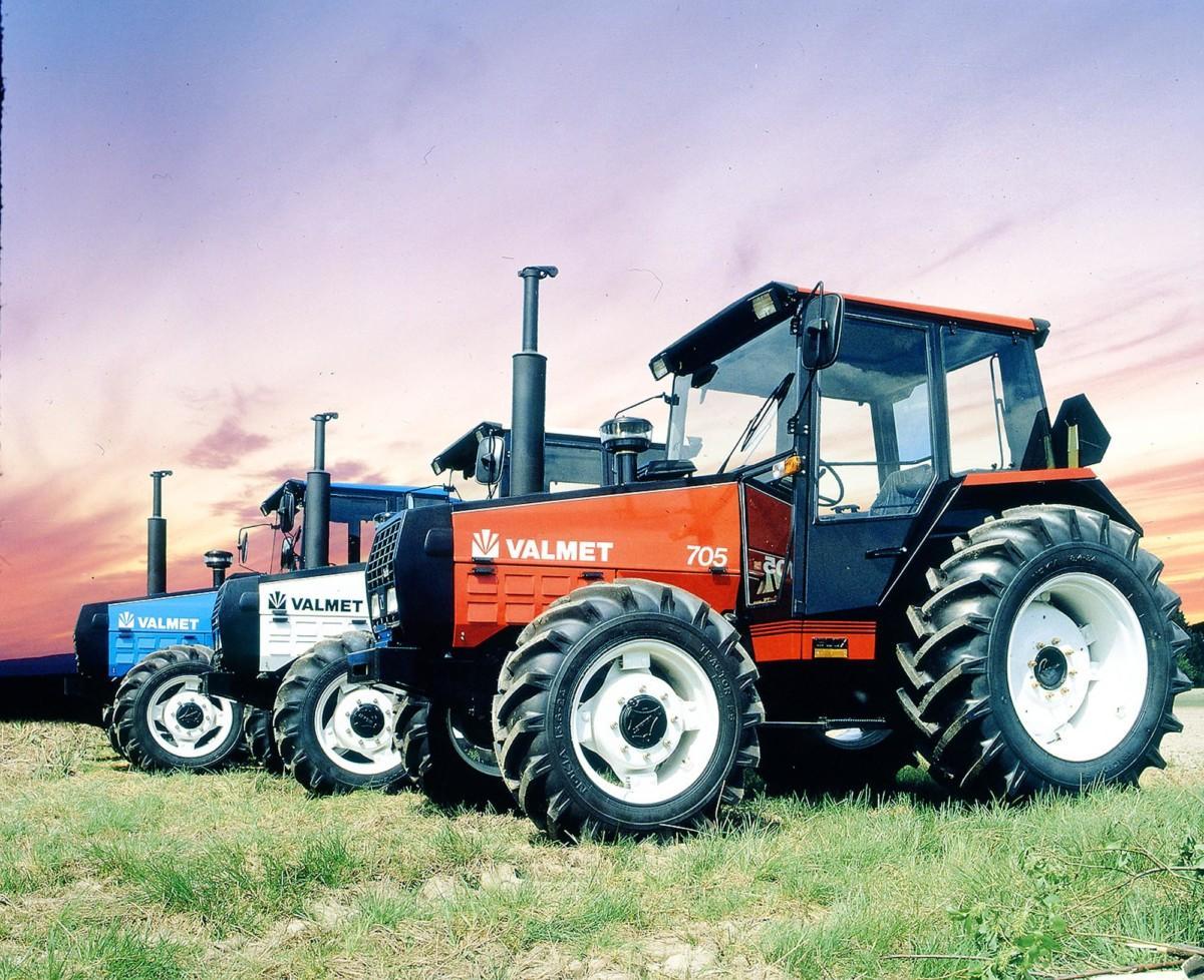 A live up of 3 blue, white, and red Valmet 705 tractors.