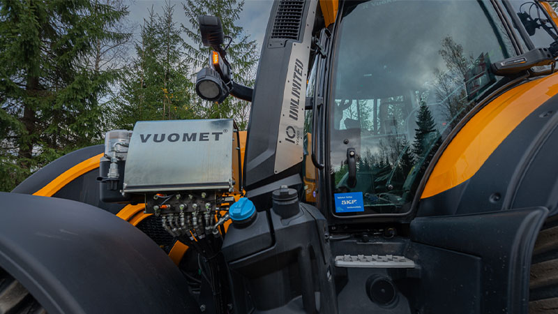 The side of a yellow Valtra Q285 tractor with the Valtra Unlimited Central Lubrication System reservoir located in an easily accessible location